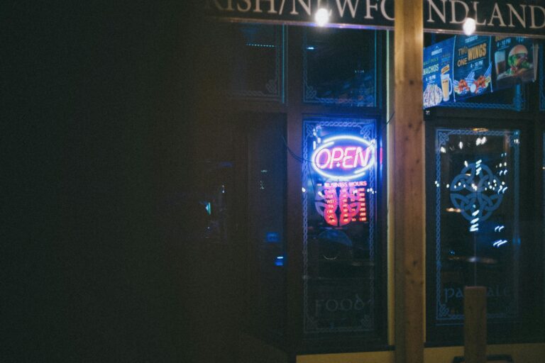 A vibrant neon restaurant sign glowing brightly at night indicating an open establishment.