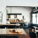 Cozy restaurant setting featuring a cheese platter and glass of wine on a rustic wooden table.