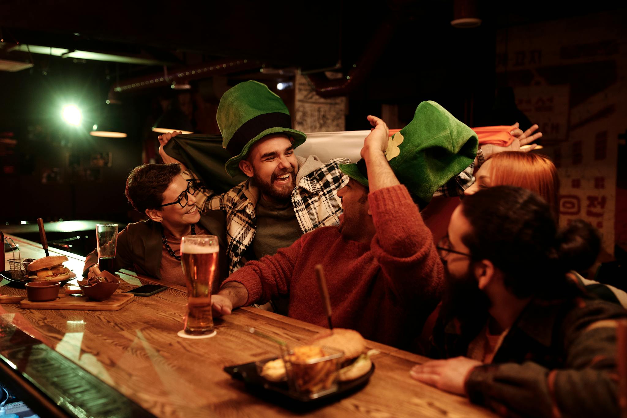 Friends celebrating St. Patrick's Day with joy and laughter at a lively bar
